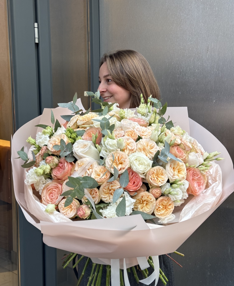 Bouquet with peony roses, roses, lisianthus (eustoma) combined with fragrant eucalyptus